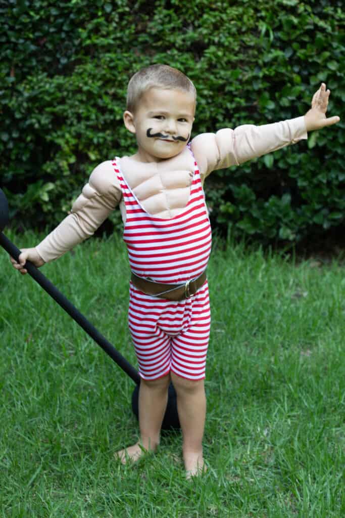 #1 DIY Muscle Man Costume | Circus Performer 9 Toddler posing in handsewn muscle man costume with accessories